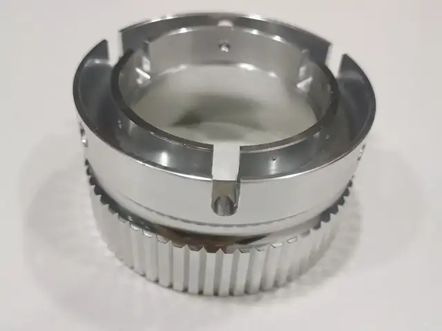 Aluminium ring with milled serrations, bayonet slots and cross-drilled ports